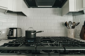 a kitchen with a stove and a pot on the stove