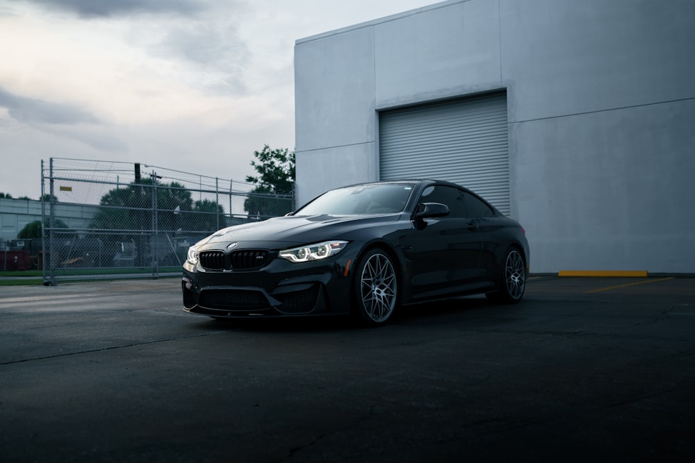 a black car parked in front of a building