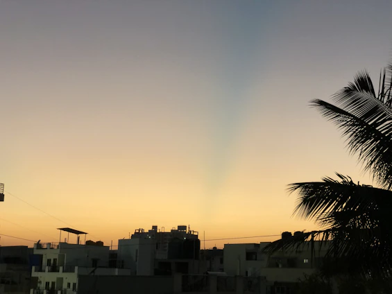 A sleek Manila skyline at dusk blending into a serene luxury beach villa setting.