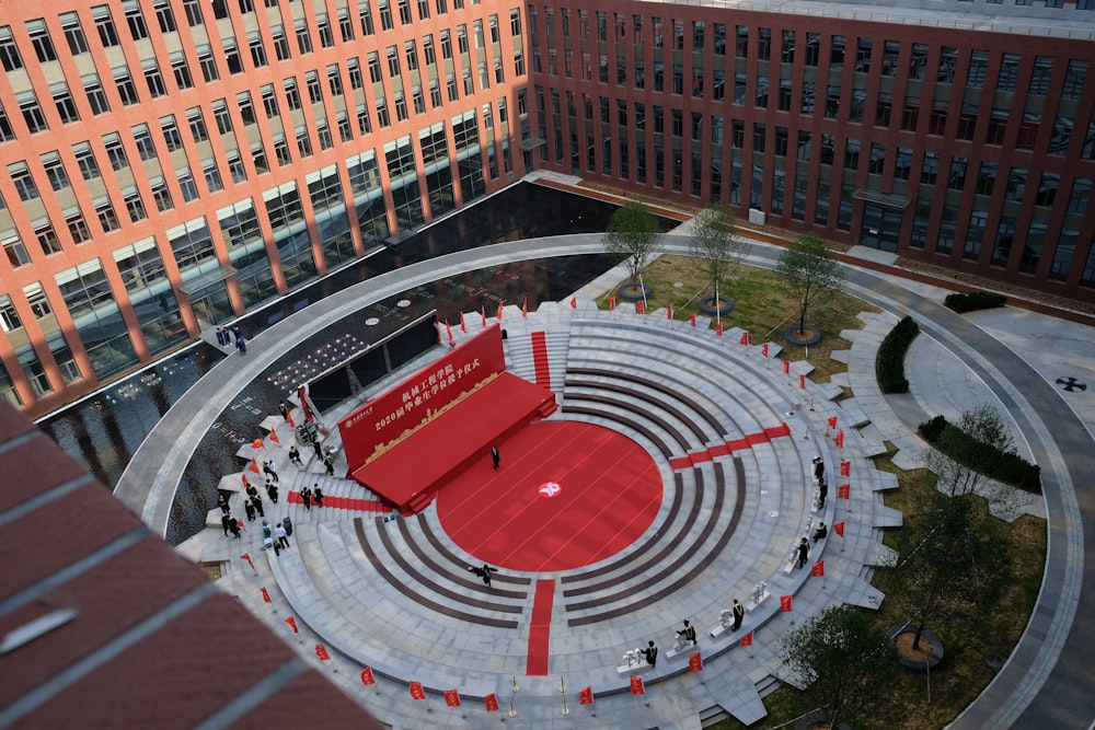 a courtyard with people and buildings around it