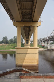 A sturdy concrete bridge under construction over a river in a heavy civil project