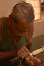 A craftsman carefully restoring the intricate woodwork of a historic home.