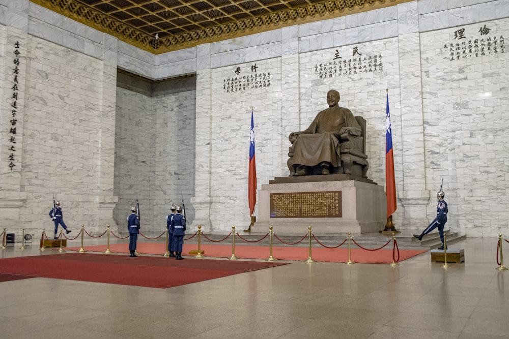 a group of people standing in front of a statue