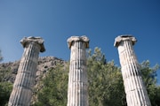 stone pillars with trees in the background