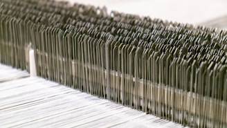 A close-up of various textile machinery parts arranged neatly.