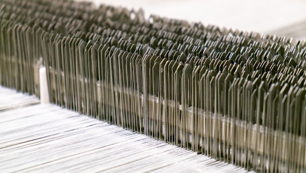 A close-up of various textile machinery parts arranged neatly.