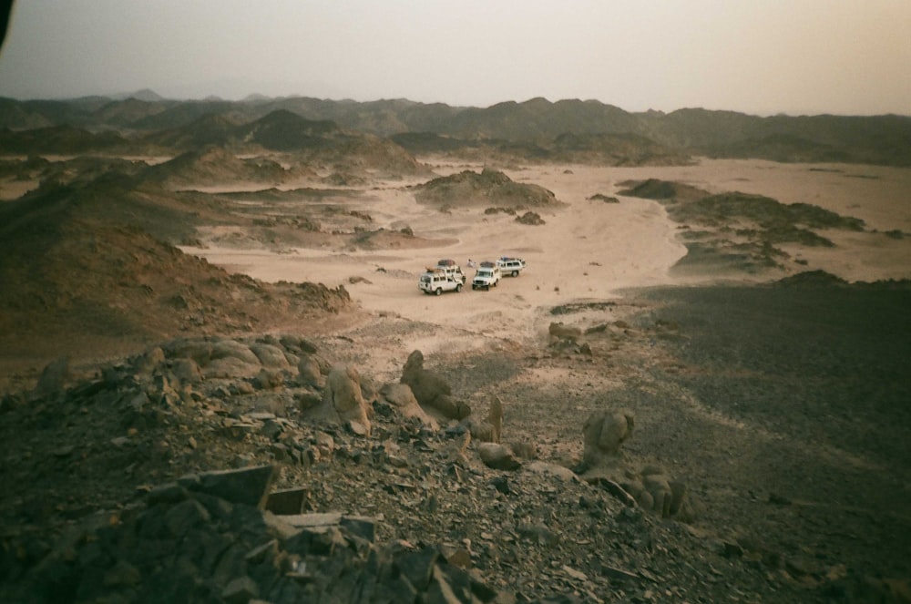 a group of vehicles parked in a desert