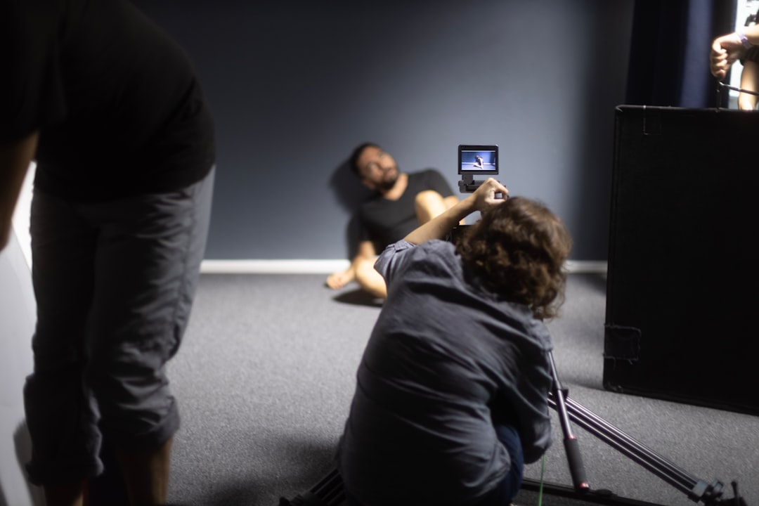 a man taking a picture of a woman lying on the floor, Prison Scene in a Classroom with the help of light #cinematography #Arri M18</p>
<p>