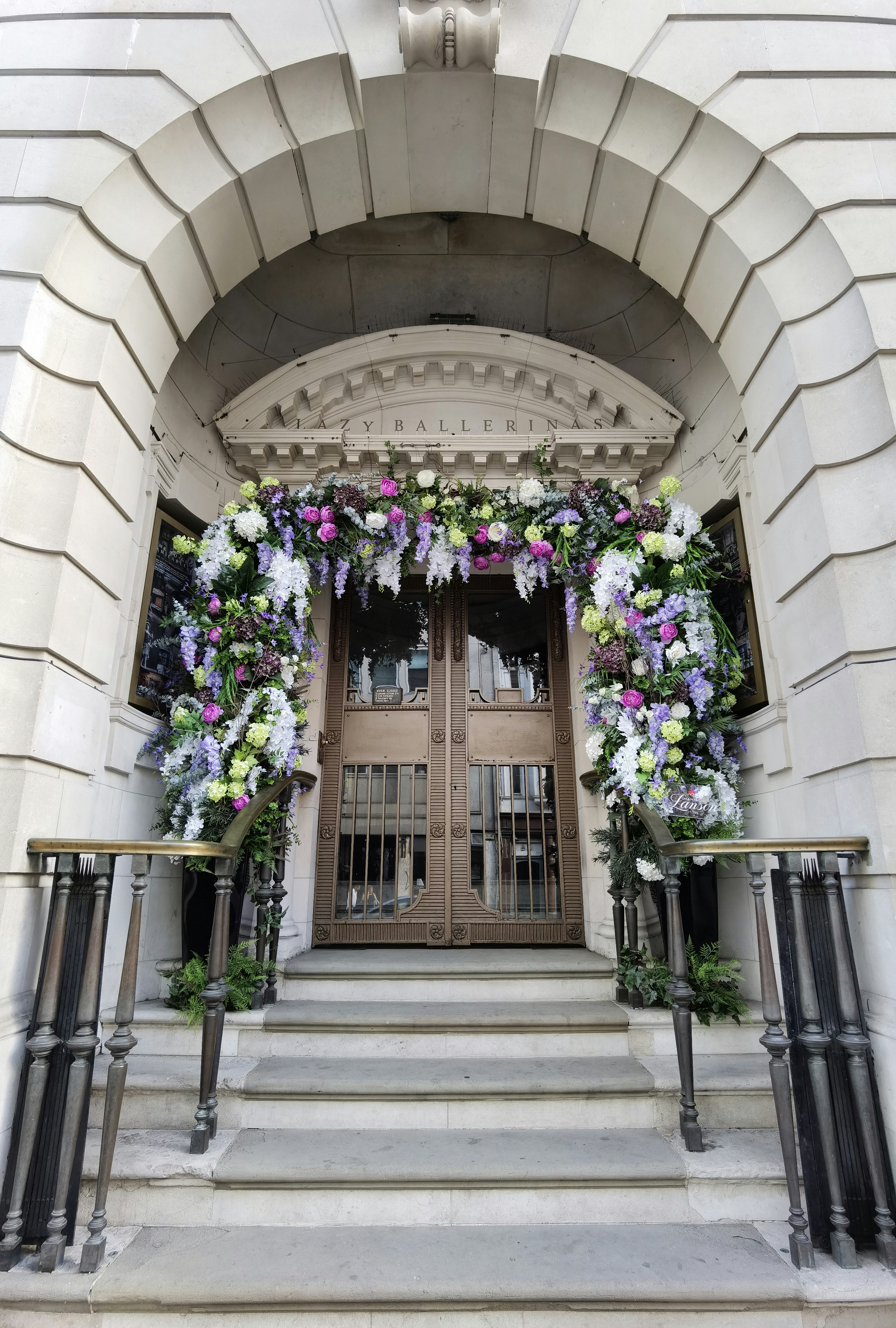 Large luxury floral installations framing an upscale event entrance