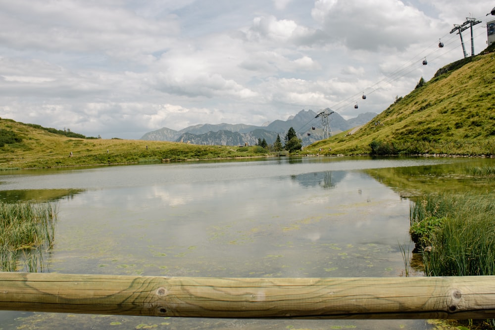 a body of water with hills in the background