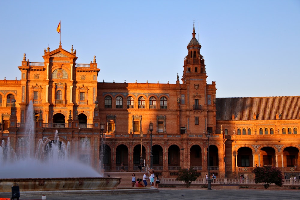 a large building with a fountain in front of it