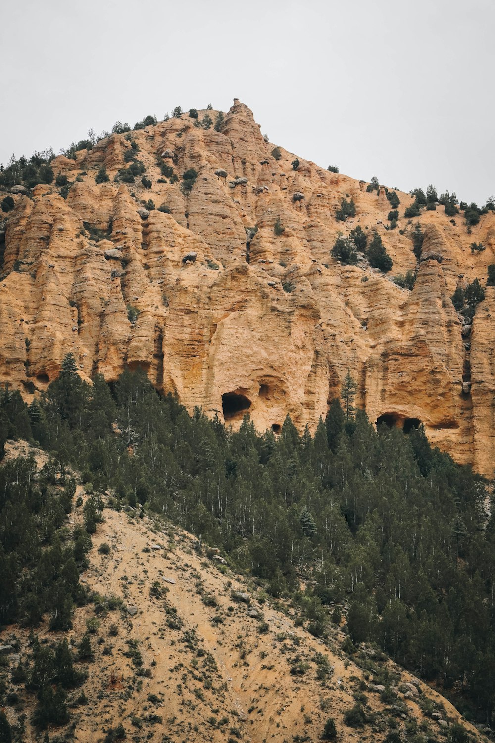 a large rock cliff with a cave