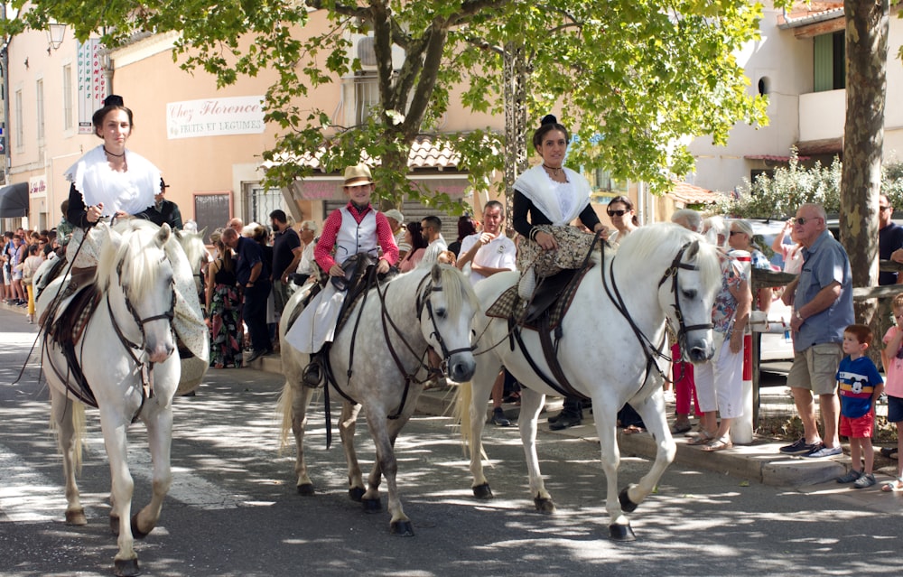 a group of people riding horses