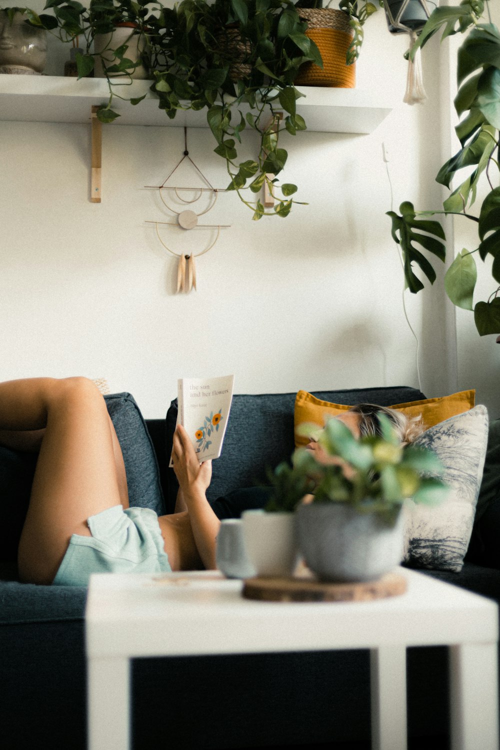 a person reading a book on a couch