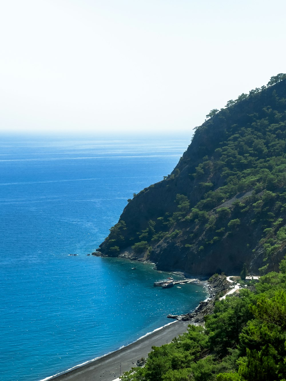 a body of water with trees on the side