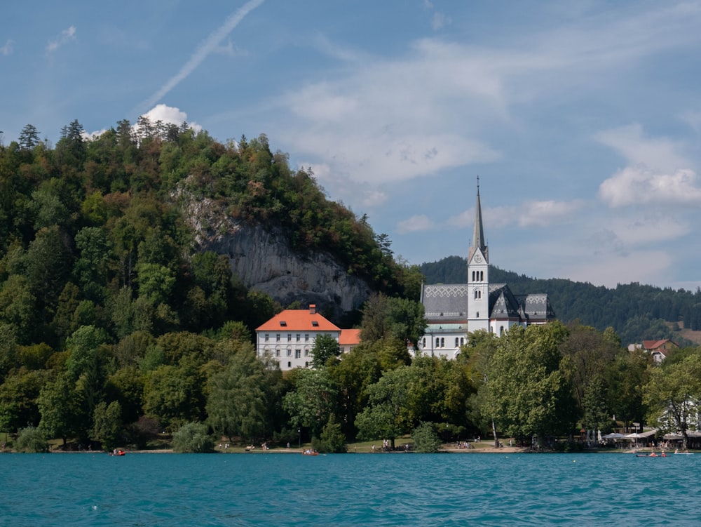 a building on a hill by a body of water