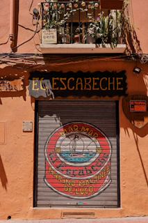 Outdoor shot of a small business storefront featuring a promotional banner designed by r.o telemercado