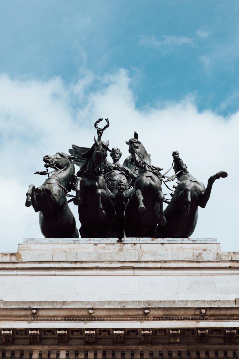 a statue of a group of men riding horses