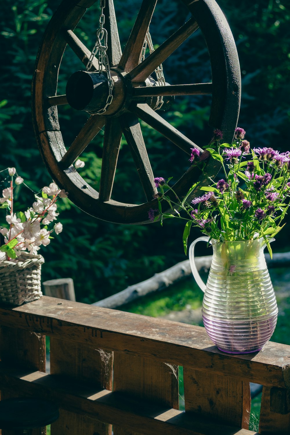 a vase with flowers on a bench