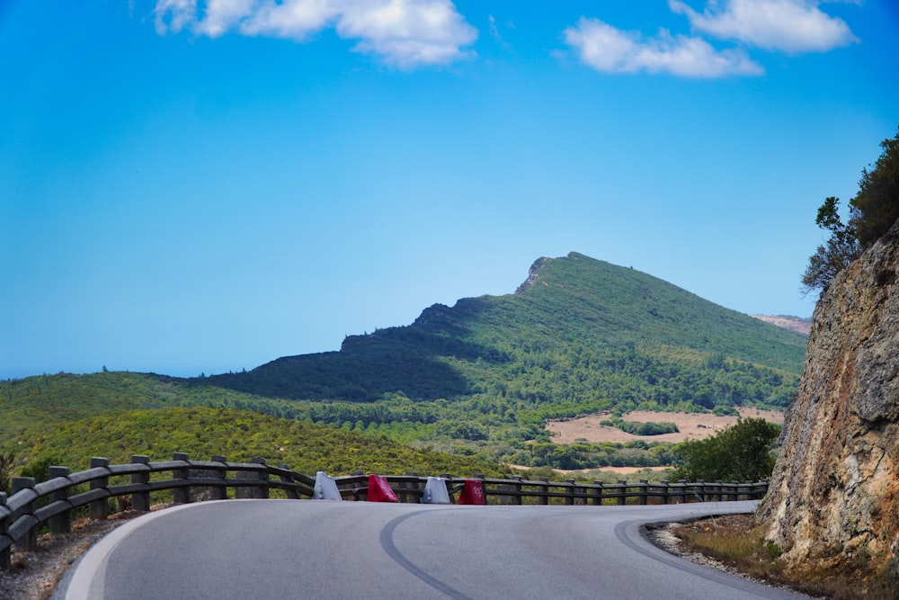 a road with a hill in the background