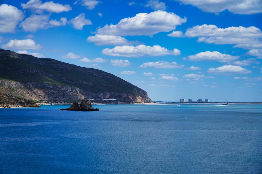 a body of water with land in the back