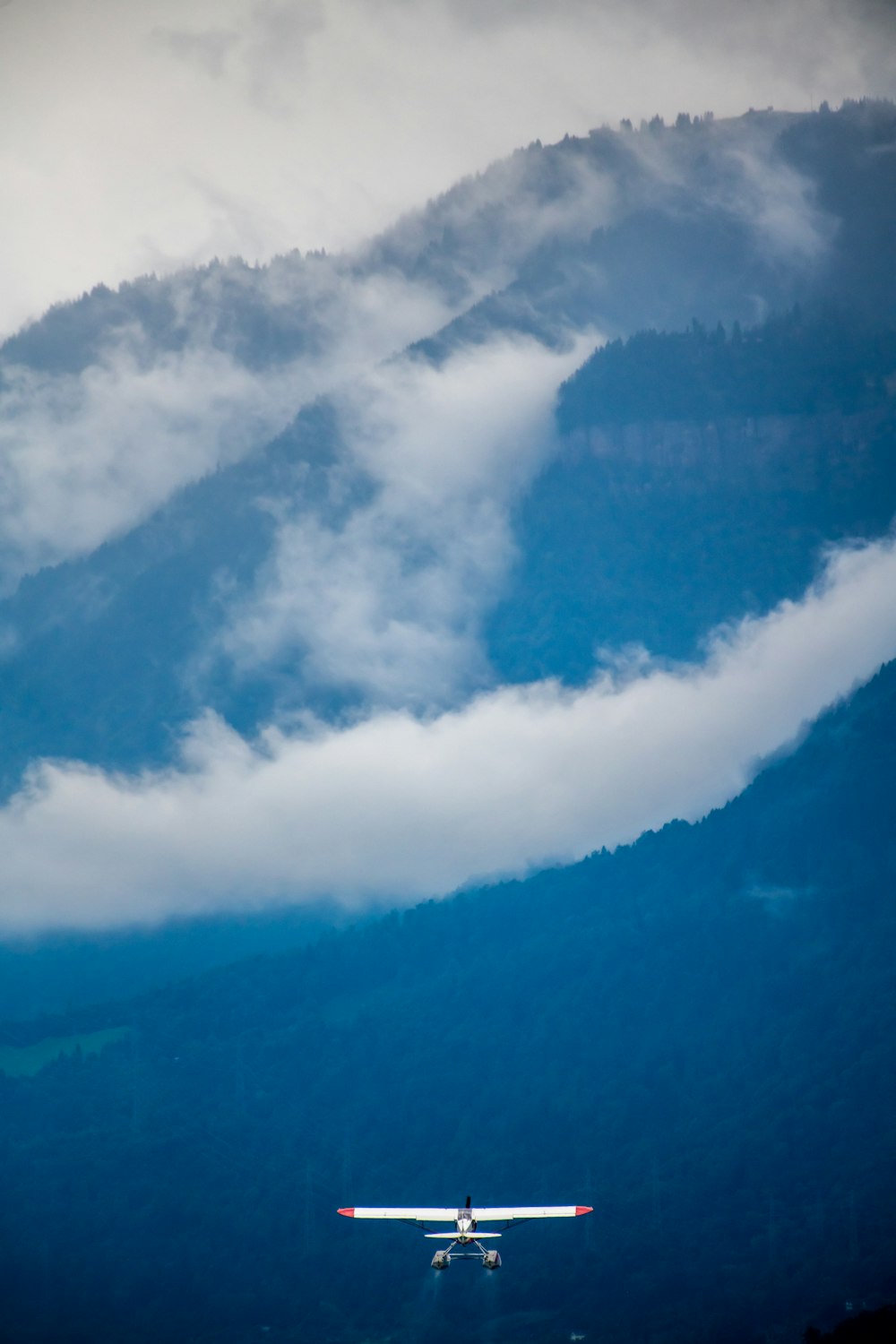 a plane flying over a mountain