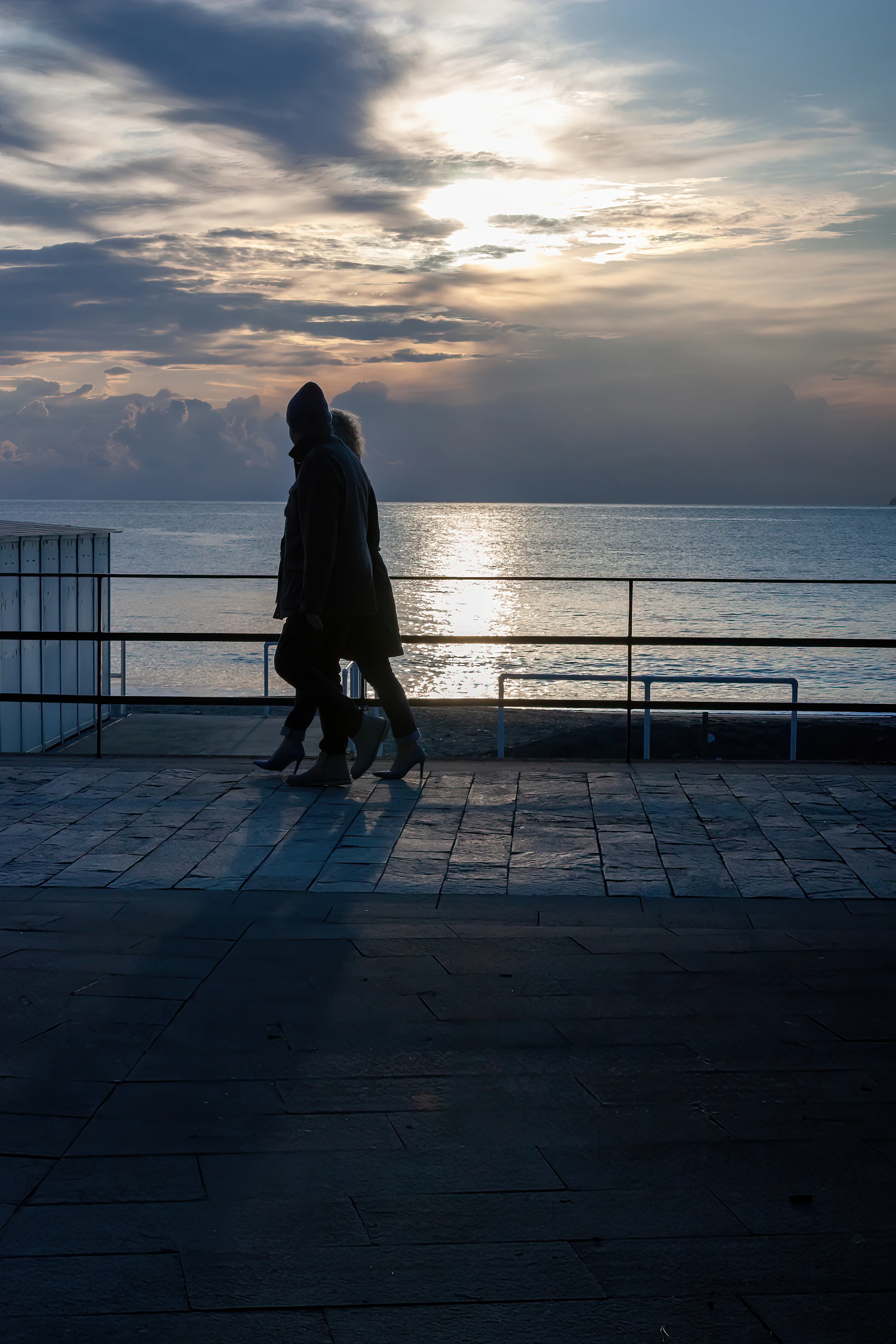 a couple people walking on a dock