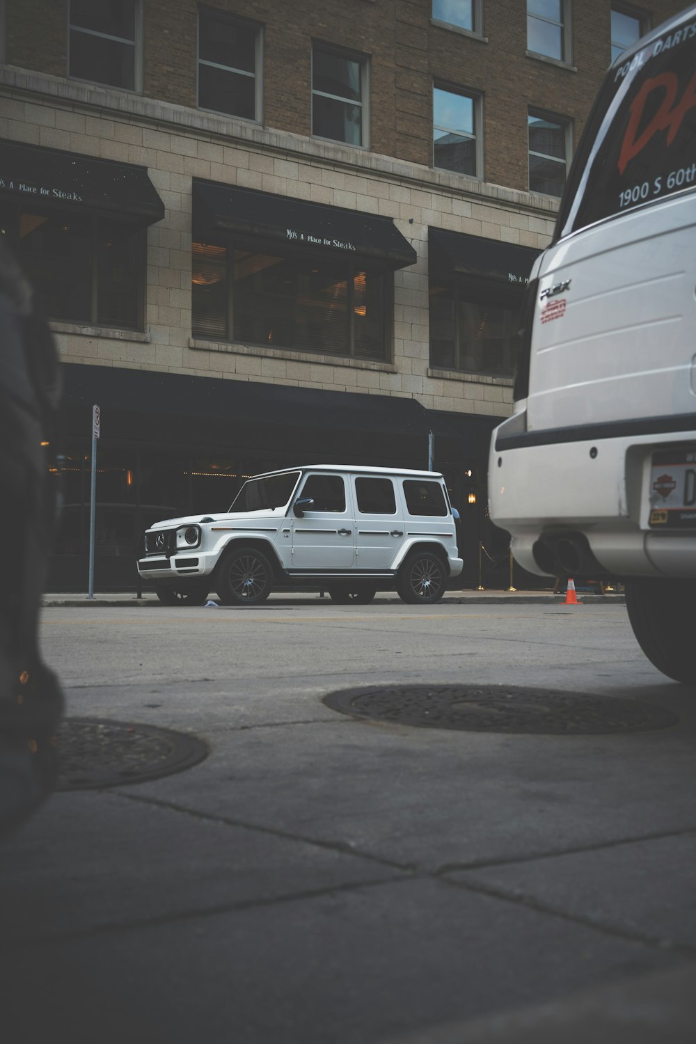 a white car parked next to a white truck