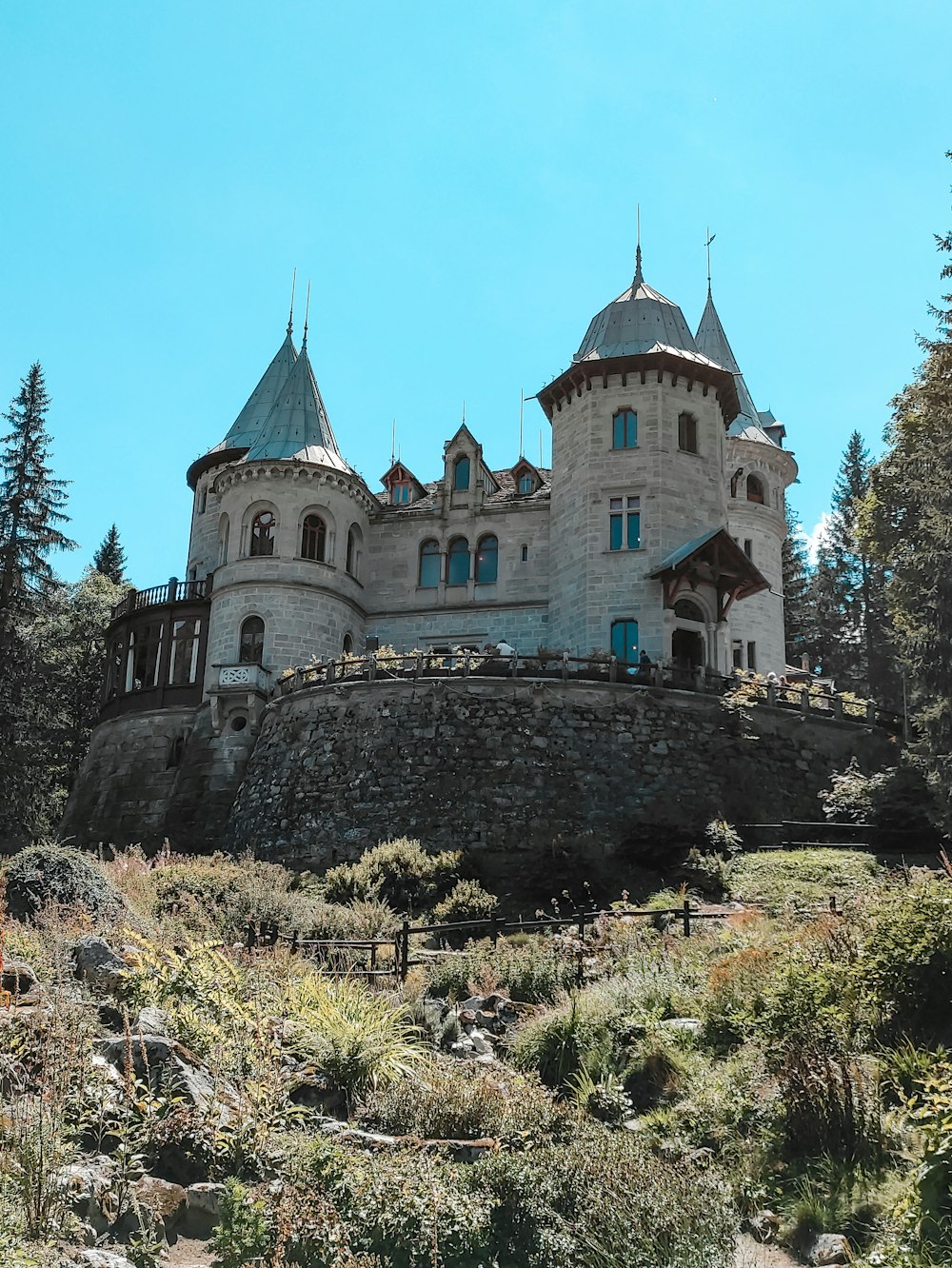 a large castle with a hill in front of it