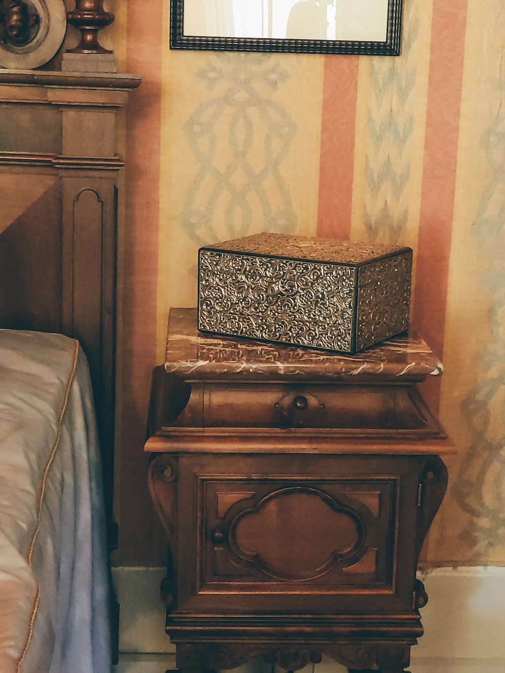 a wooden chest with a mirror on top