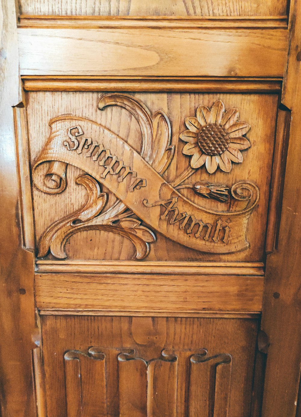 a wood door with a carved face