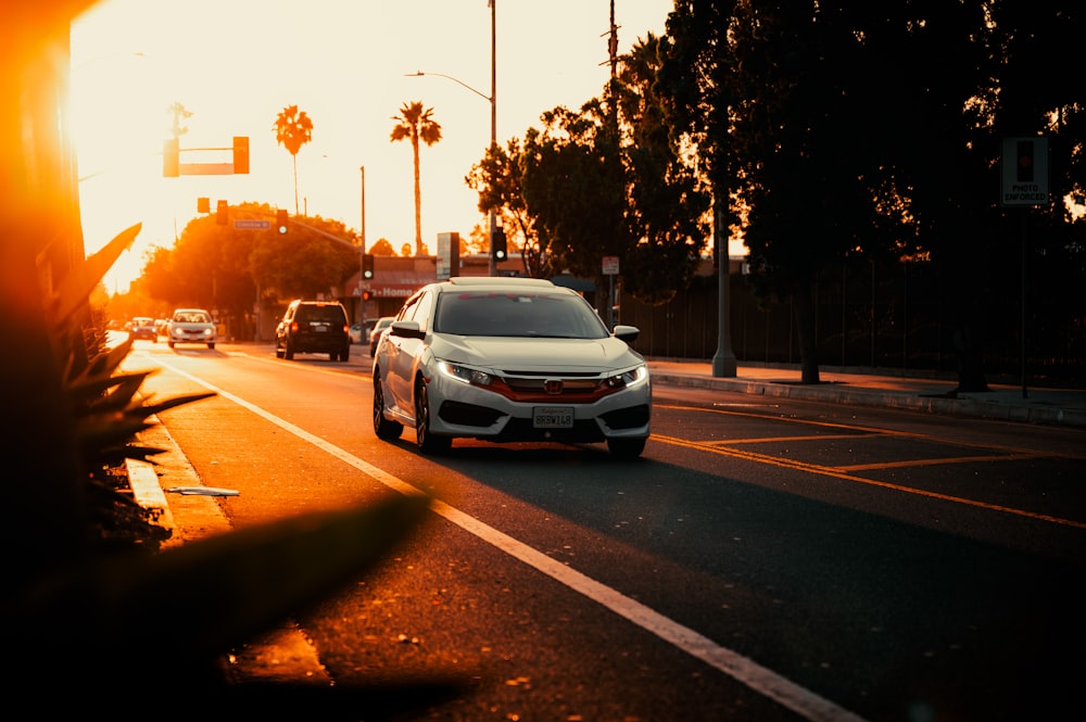 a group of cars driving down a street