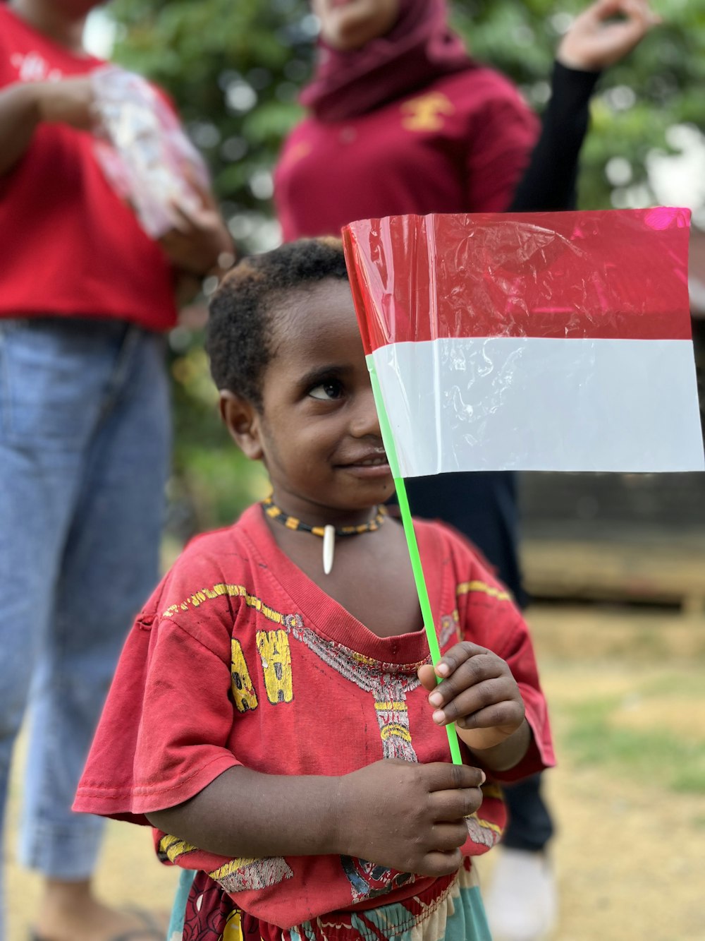 a young girl holding a stick