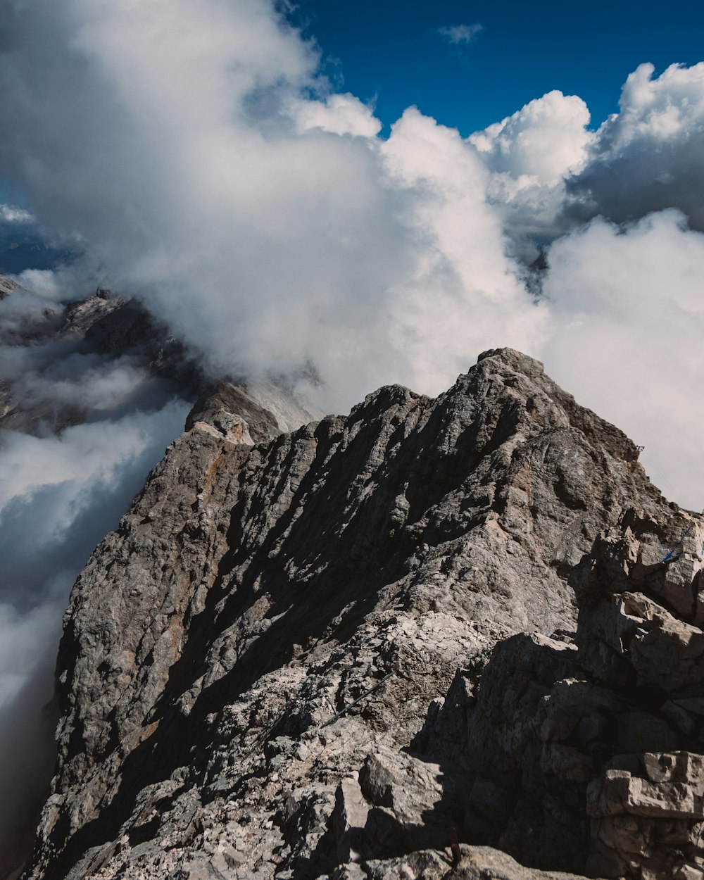 a mountain with clouds above it