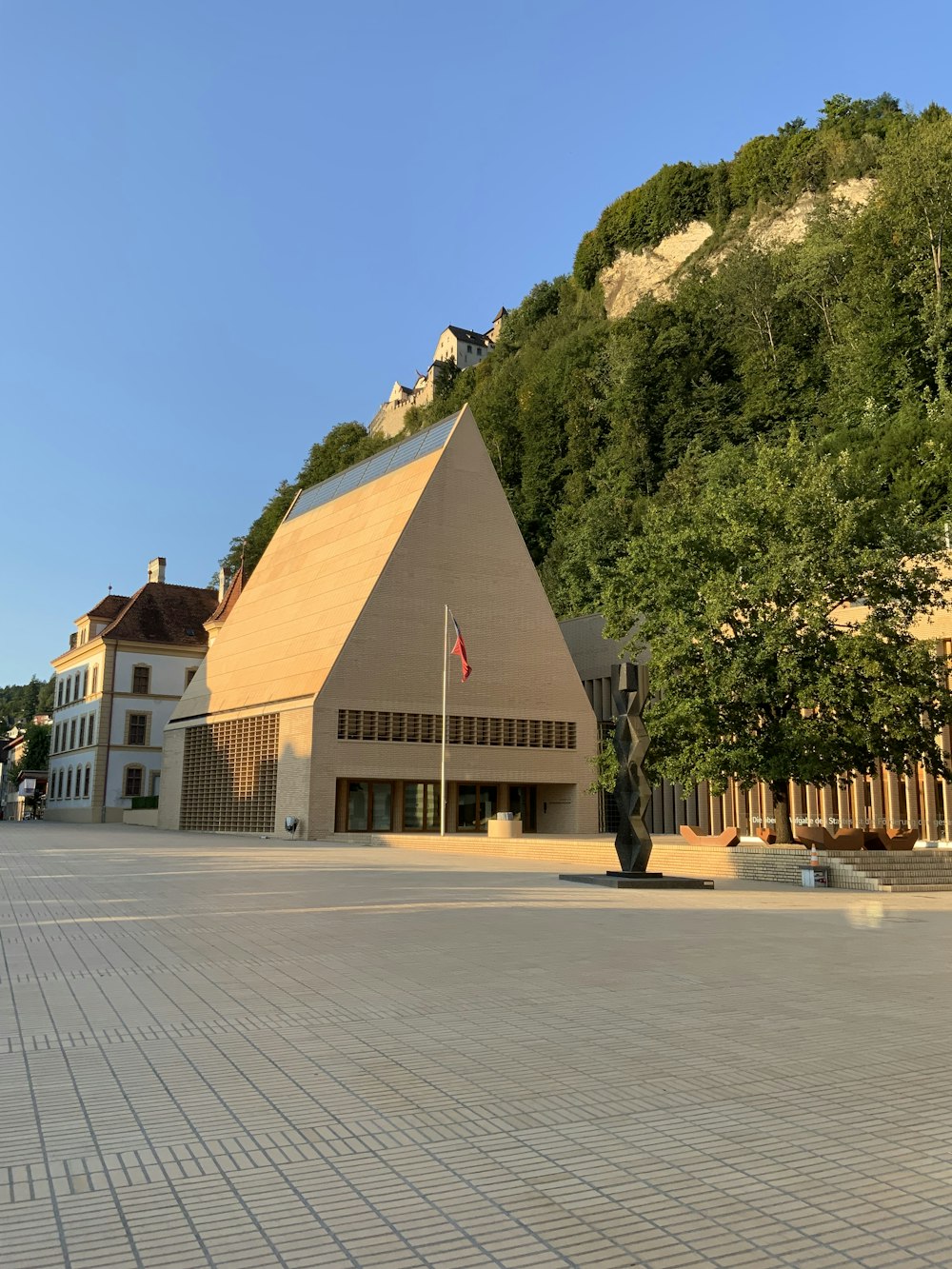 a building with a hill in the background