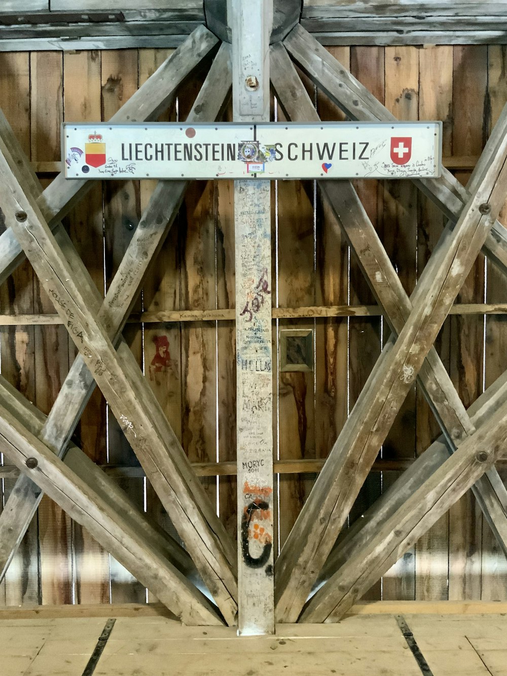 a wooden sign on a wooden fence