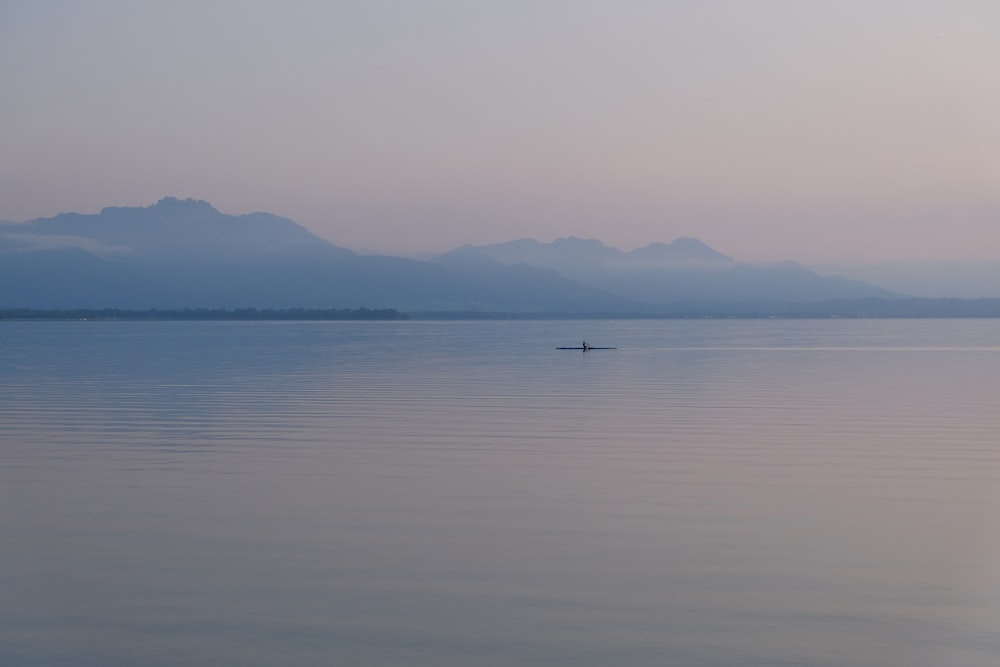 a body of water with mountains in the background