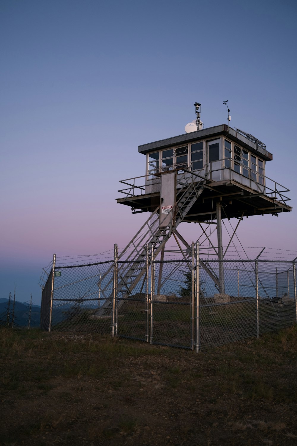 a structure outside with a fence around it