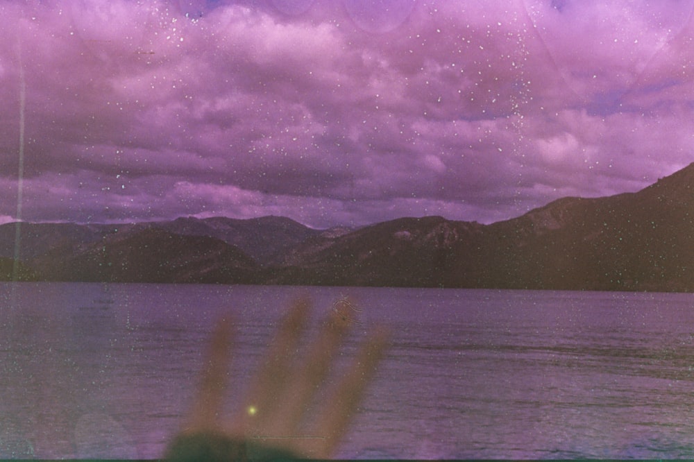 a body of water with mountains in the background