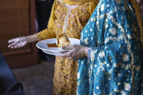 a person holding a plate of food