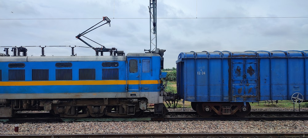 a blue train on the tracks