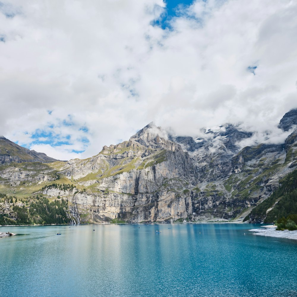 a body of water with mountains in the back