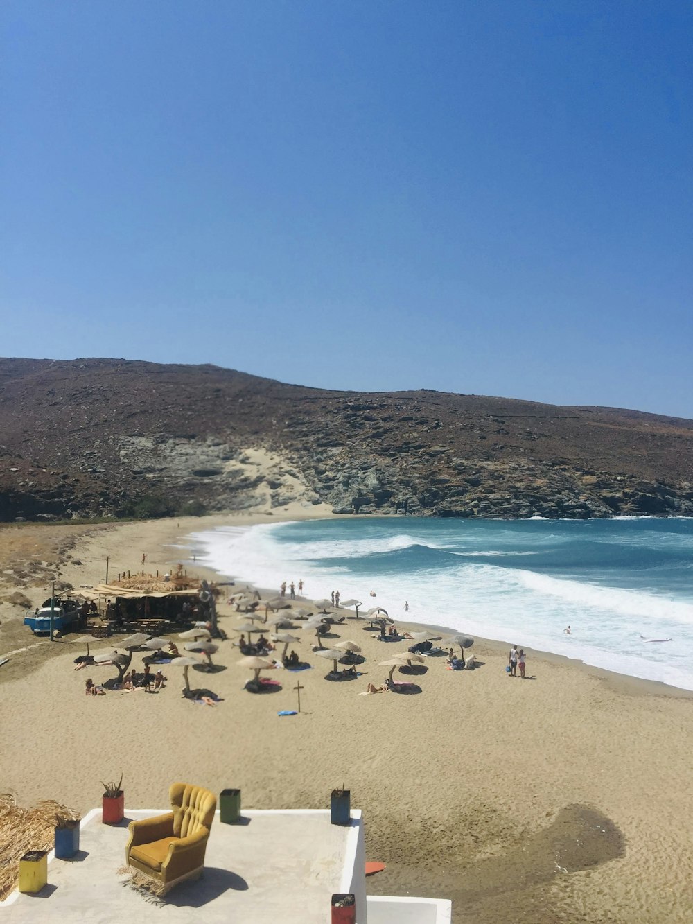 a beach with people and chairs