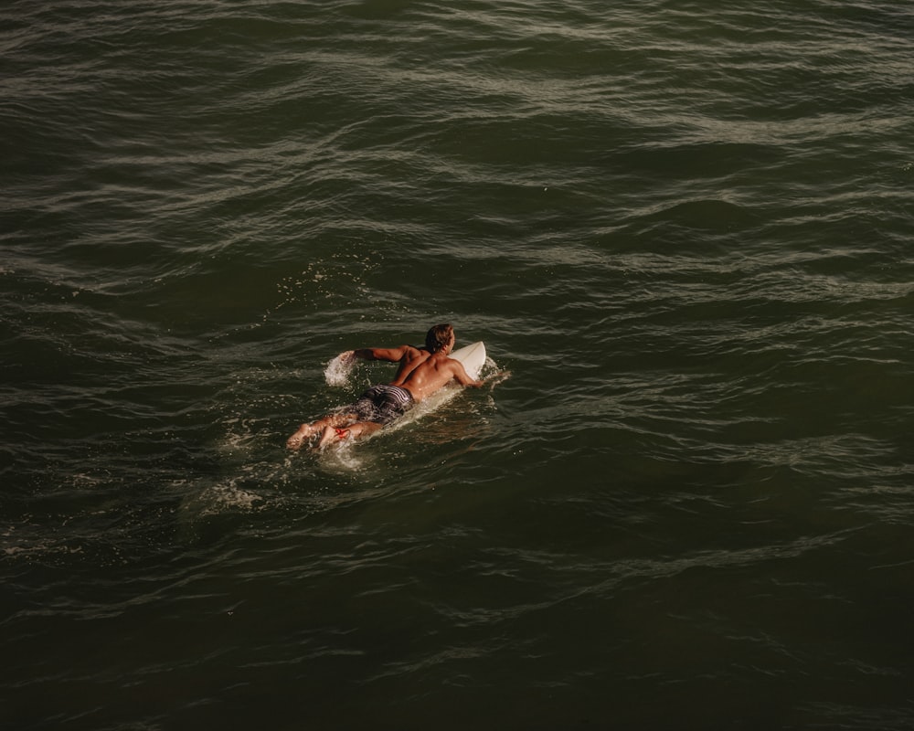 a man on a surfboard in the water