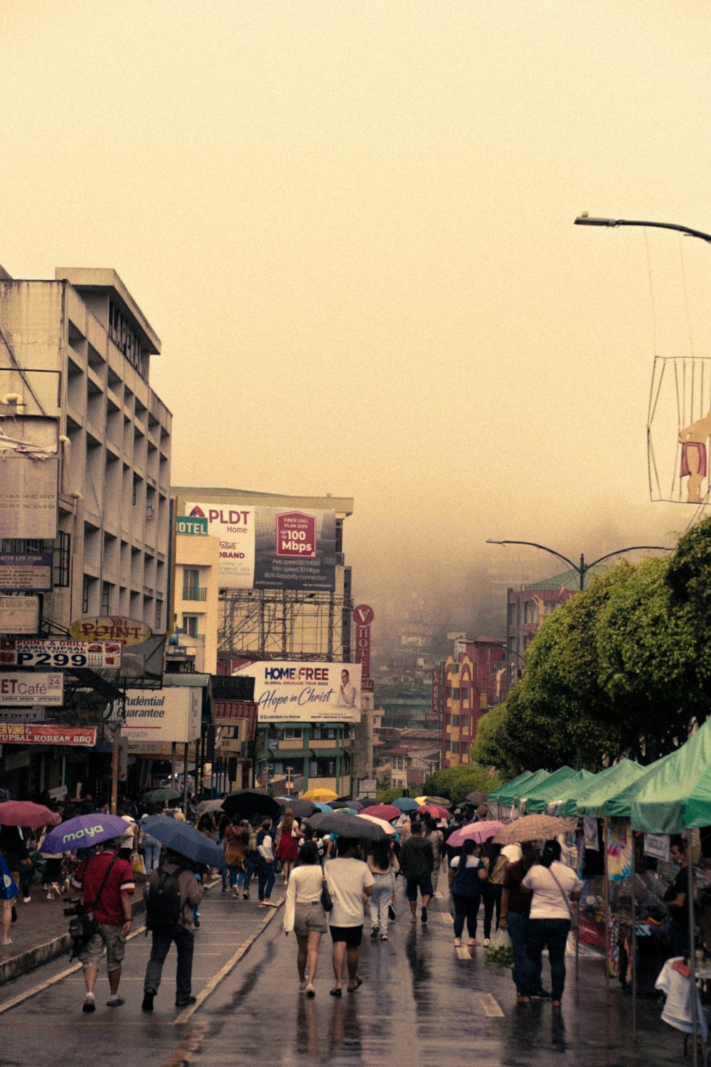 people walking in the street with umbrellas