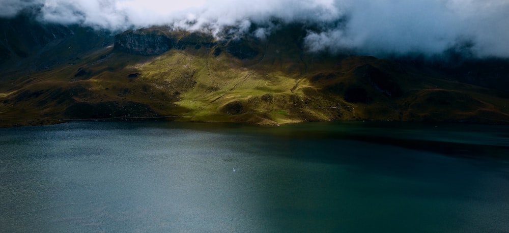 a body of water with hills in the back