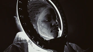 Applying textured paint and stains to a mask under moody lighting.