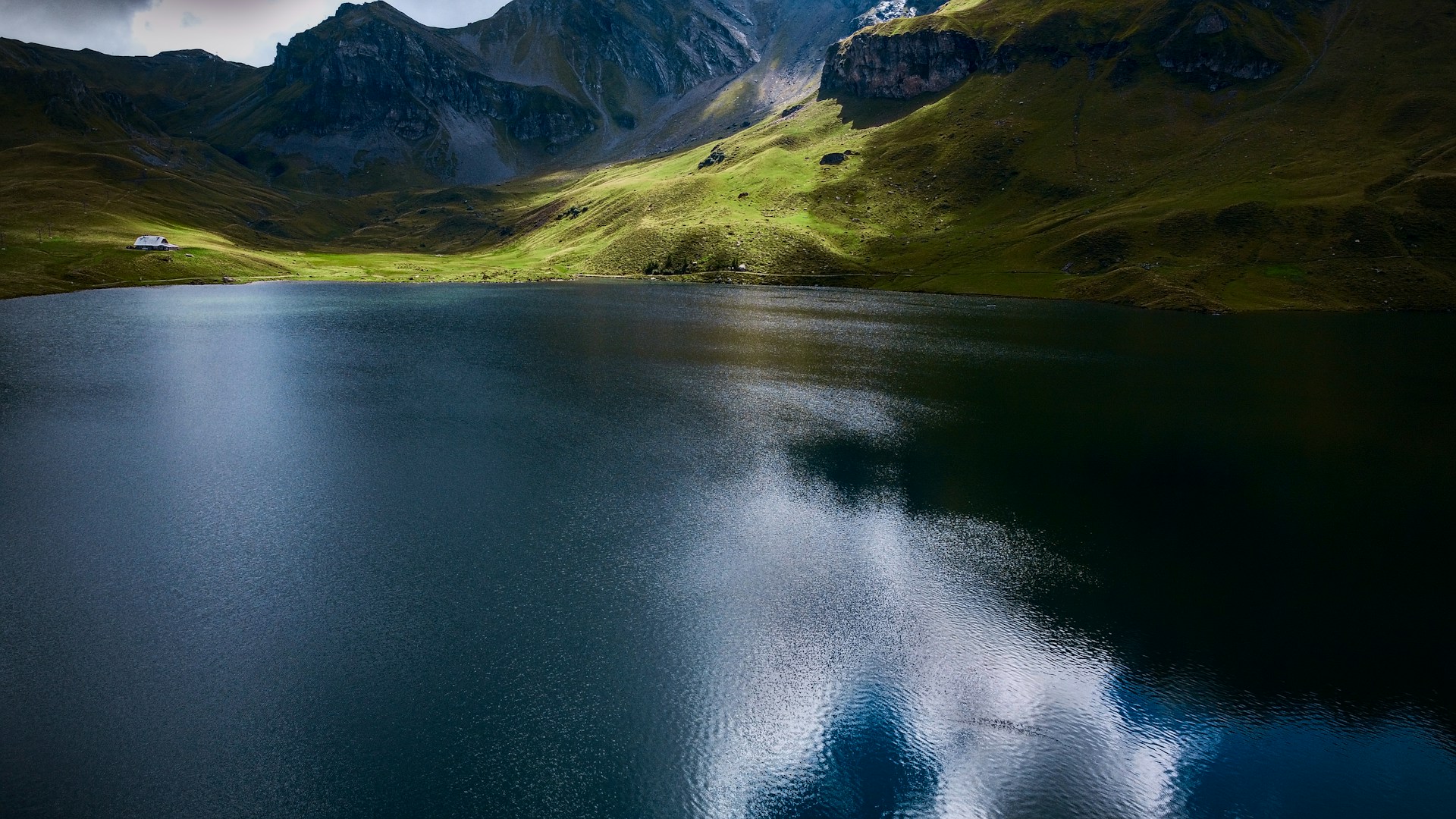 a body of water with mountains in the background
