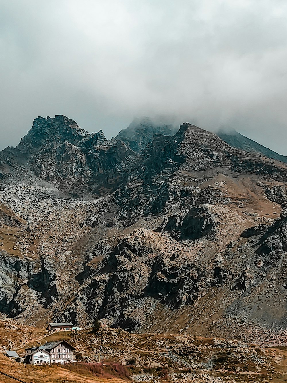 a rocky mountain with a house