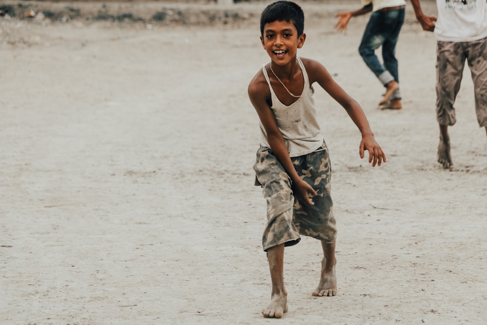 a boy running on a beach